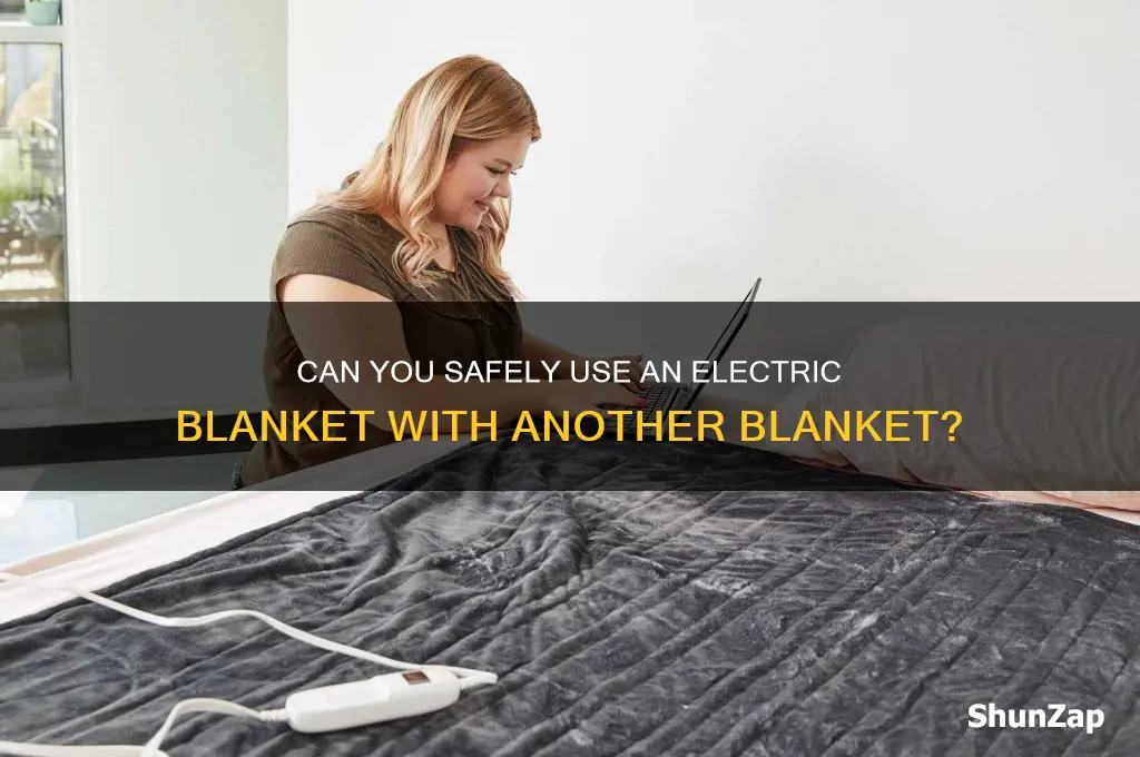 can an electric blanket be used with another blanket