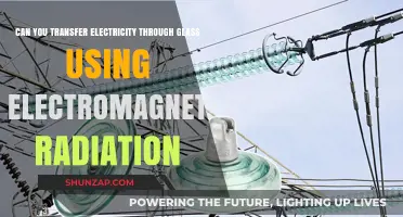 Transferring Electricity Through Glass: The Role of Electromagnetic Radiation
